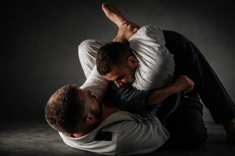 Dedicated practitioners grappling during live drills at our Jiu-Jitsu academy in Chantilly VA on safety mats.